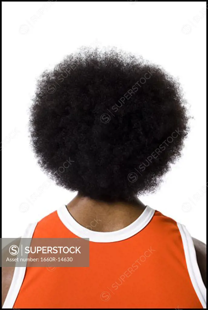 Basketball player with an afro in orange uniform