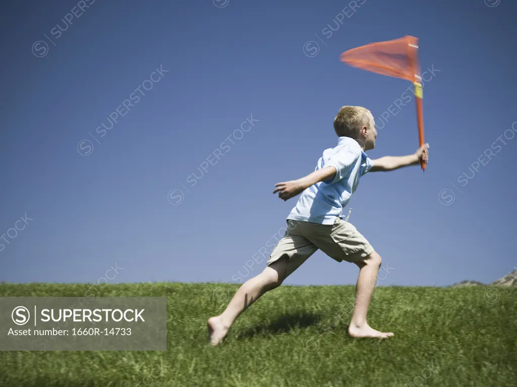 Boy playing on a hill