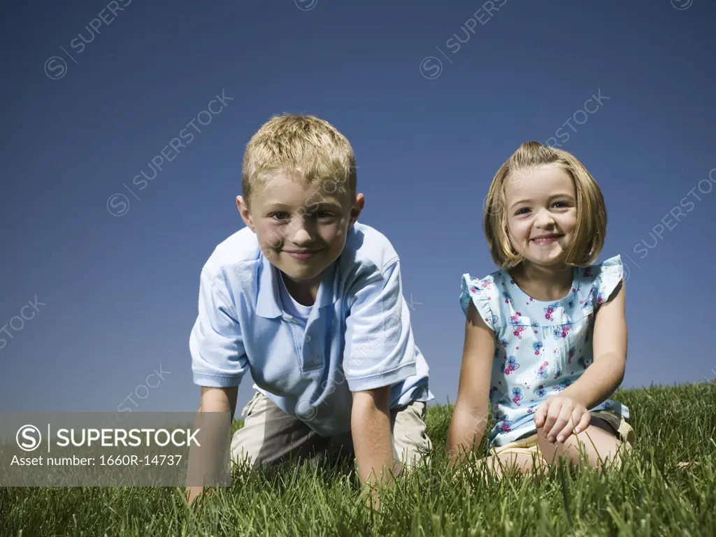 Boy and girl sitting on a hill