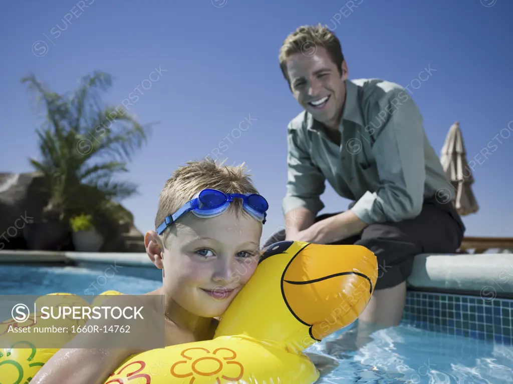 Father and son at swimming pool