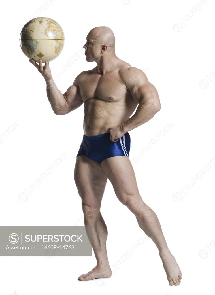 Male bodybuilder holding a desk globe