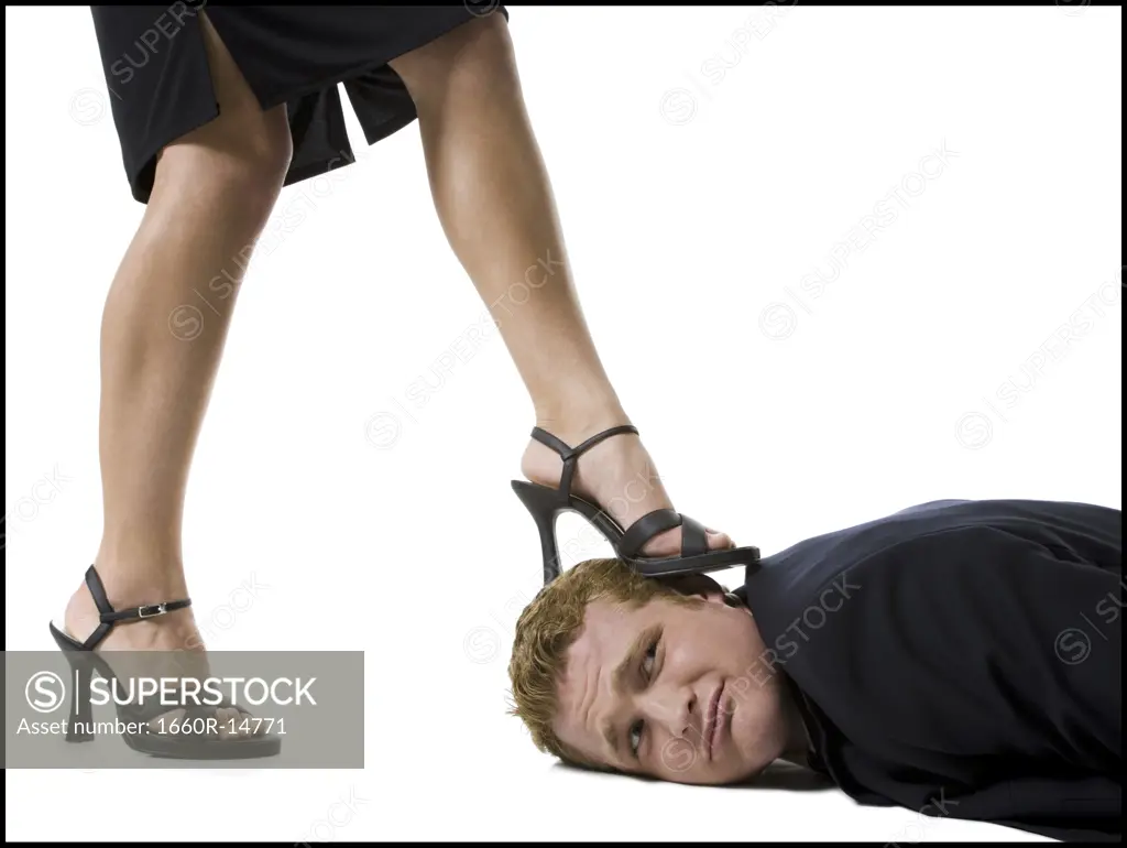 Woman stepping on man's face with heels