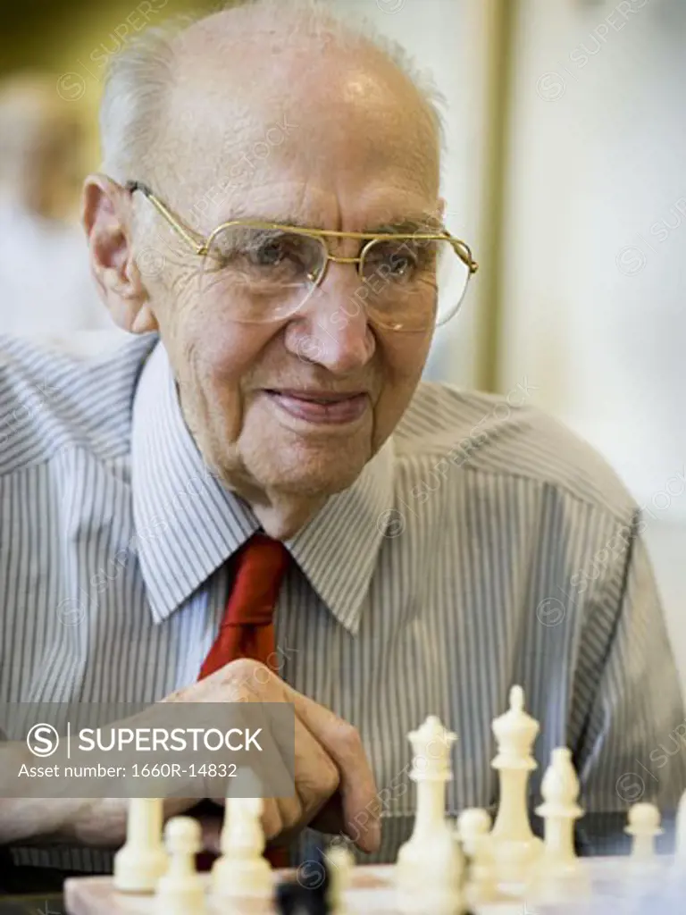Elderly man playing chess