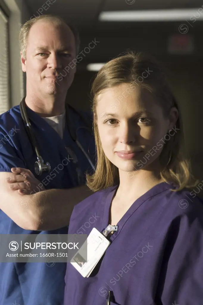 Portrait of a female doctor with a male doctor standing behind her