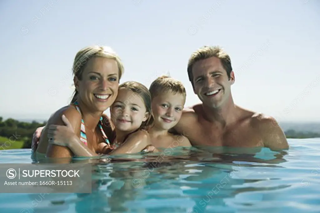 Family in infinity pool