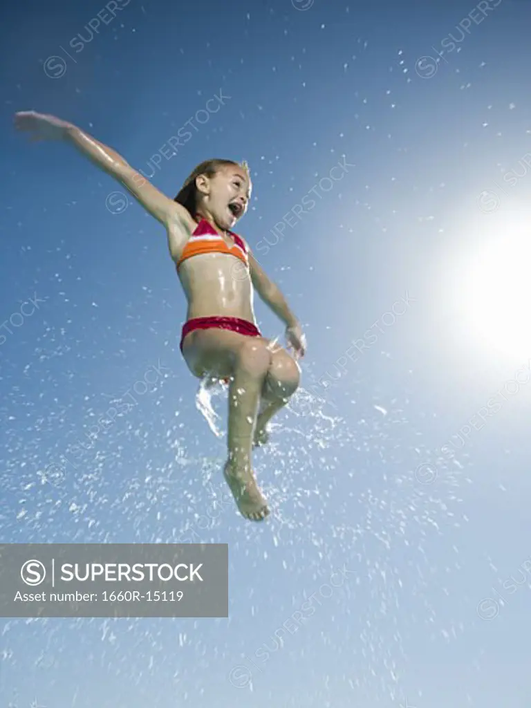 Young girl jumping in water