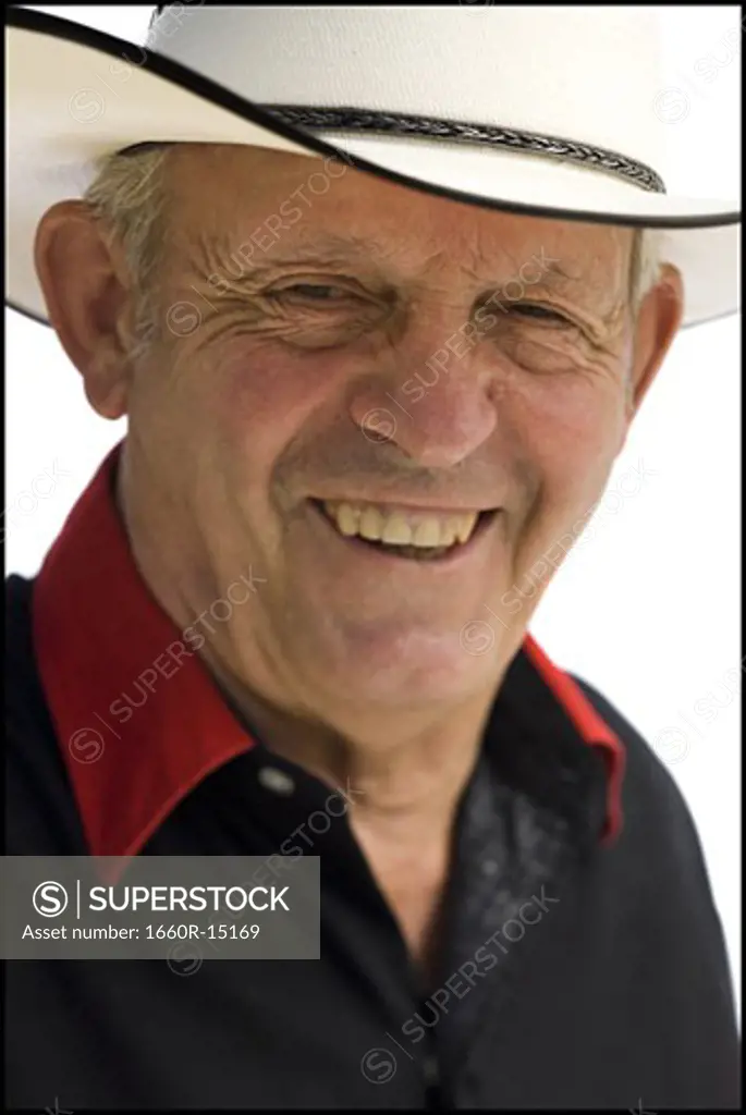 Older man in a western shirt with a cowboy hat