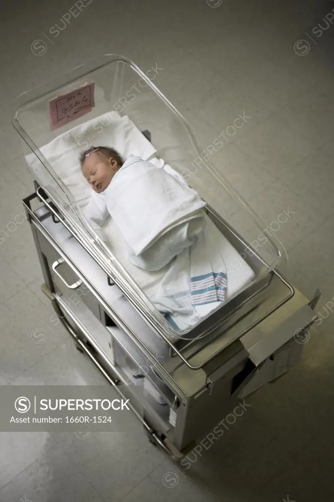 High angle view of a baby boy lying in a hospital nursery