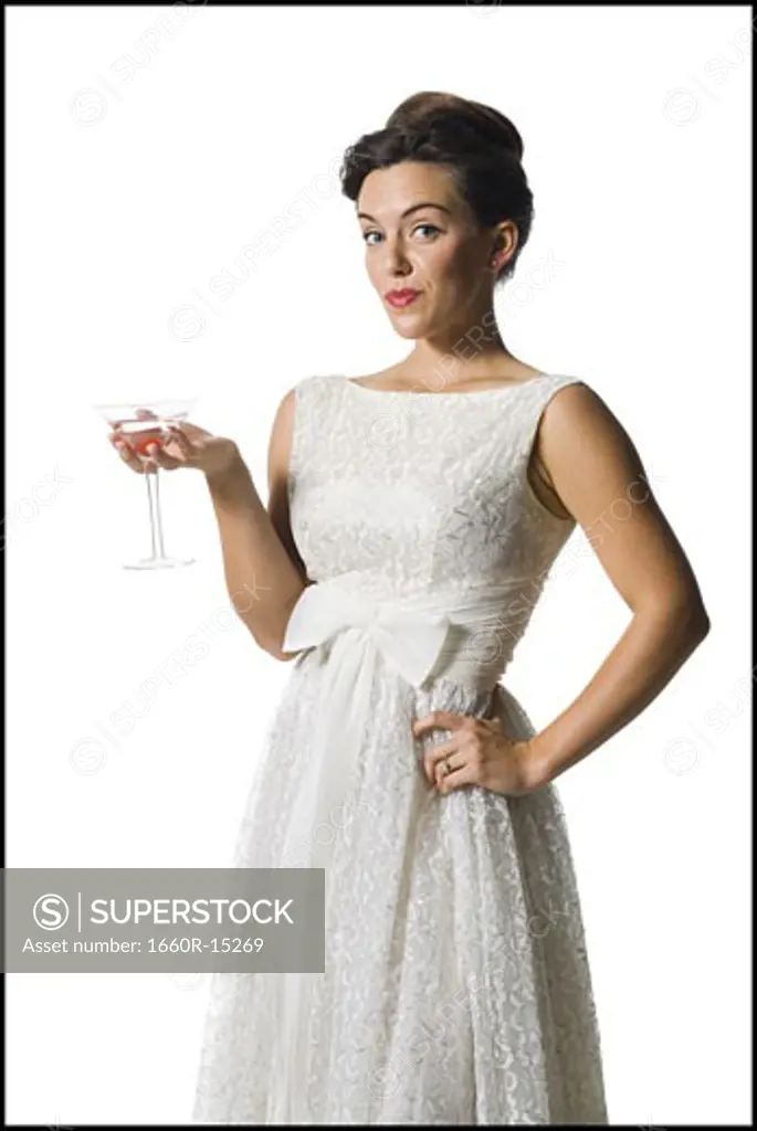 Woman in white dress holding martini glass