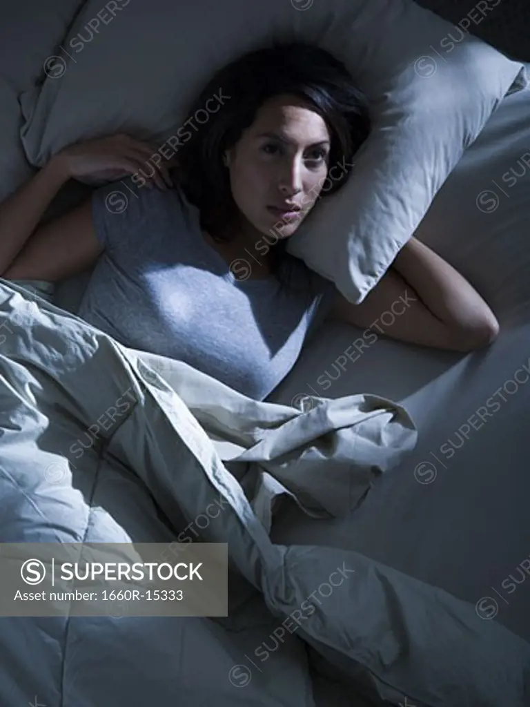 Woman in bed in the dark