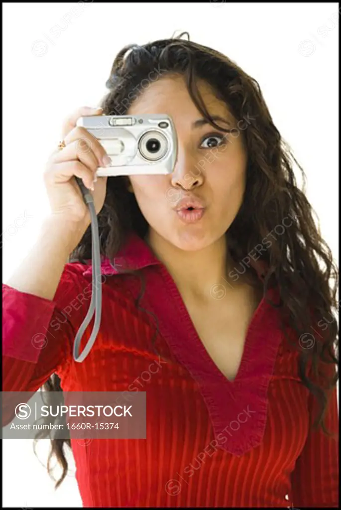 Woman in red shirt taking picture with digital camera