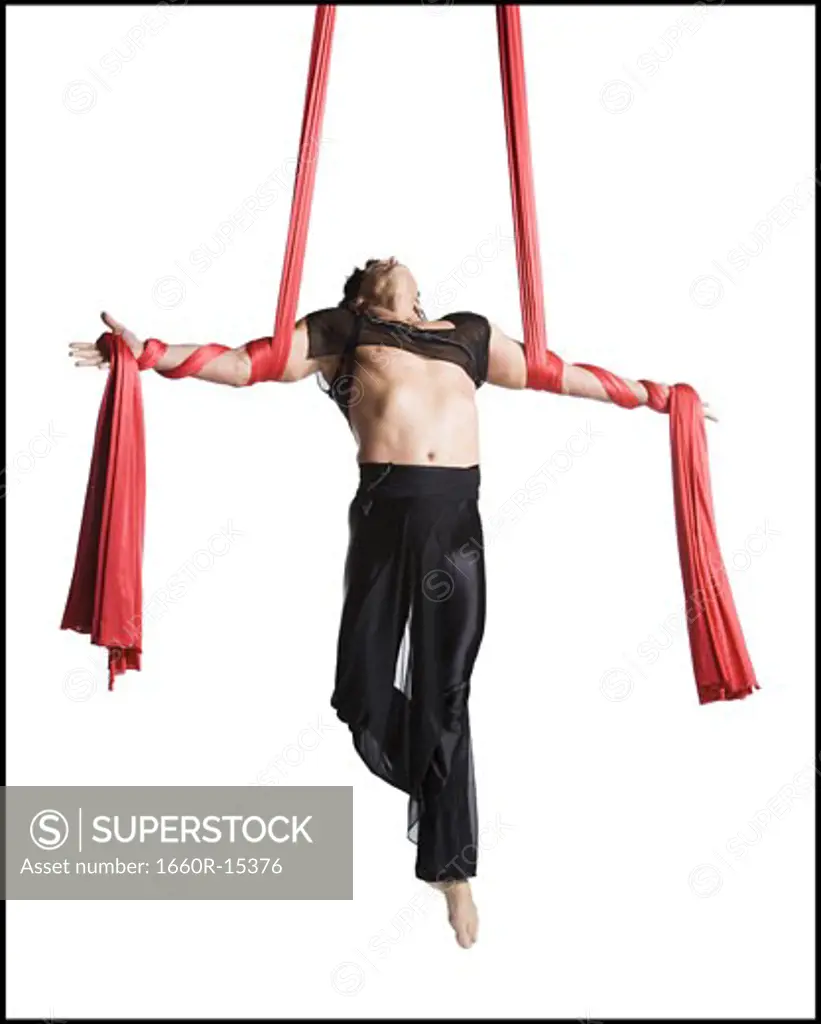 Man tangled in red drapes