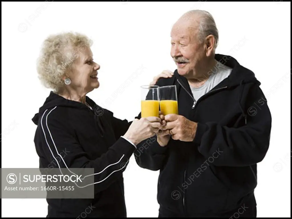 Older couple in track suits taking a juice break