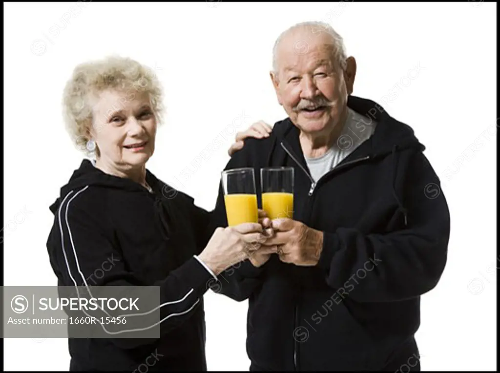 Older couple in track suits taking a juice break