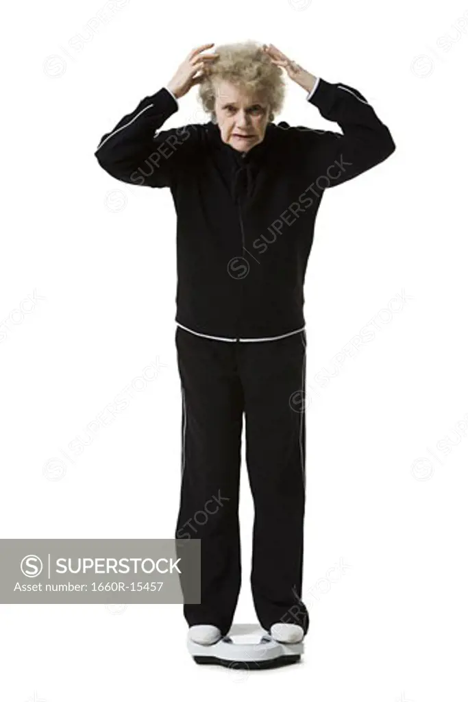 Older woman weighing herself on a bathroom scale