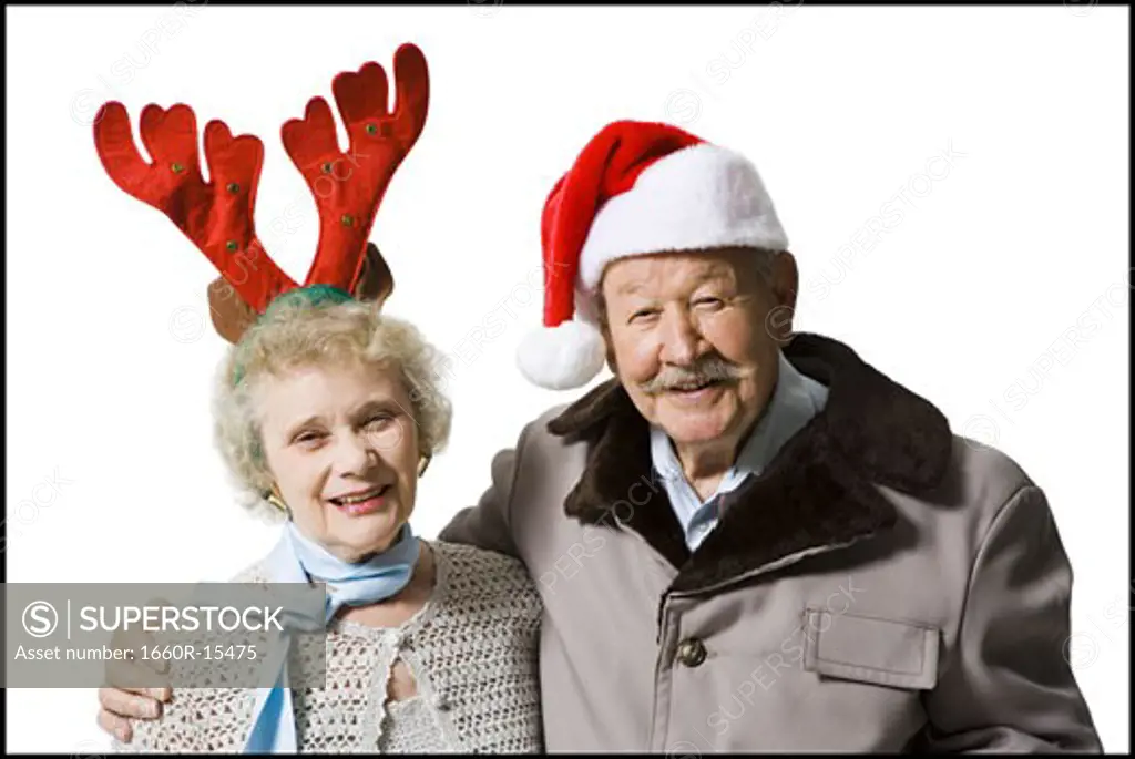 Older couple wearing Christmas hats