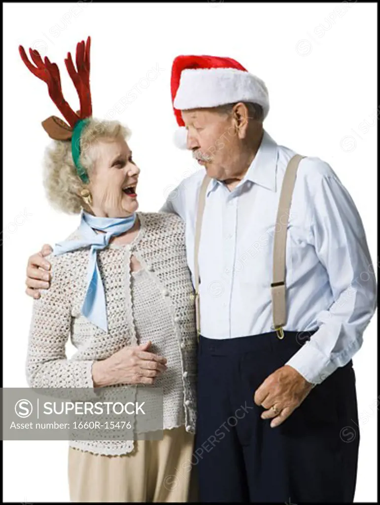 Older couple wearing Christmas hats