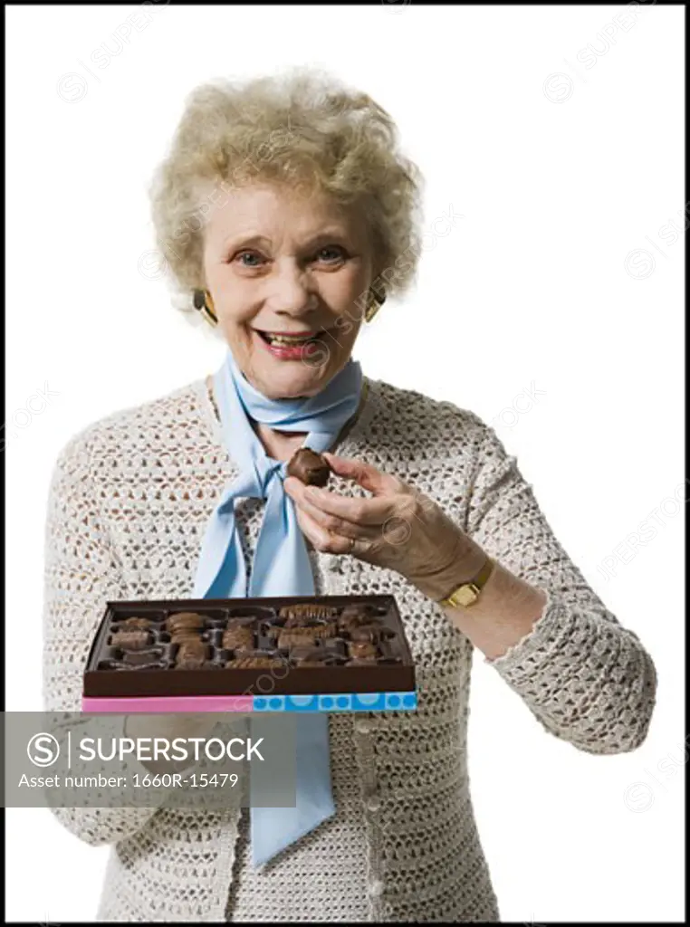 Older woman holding a box of chocolates