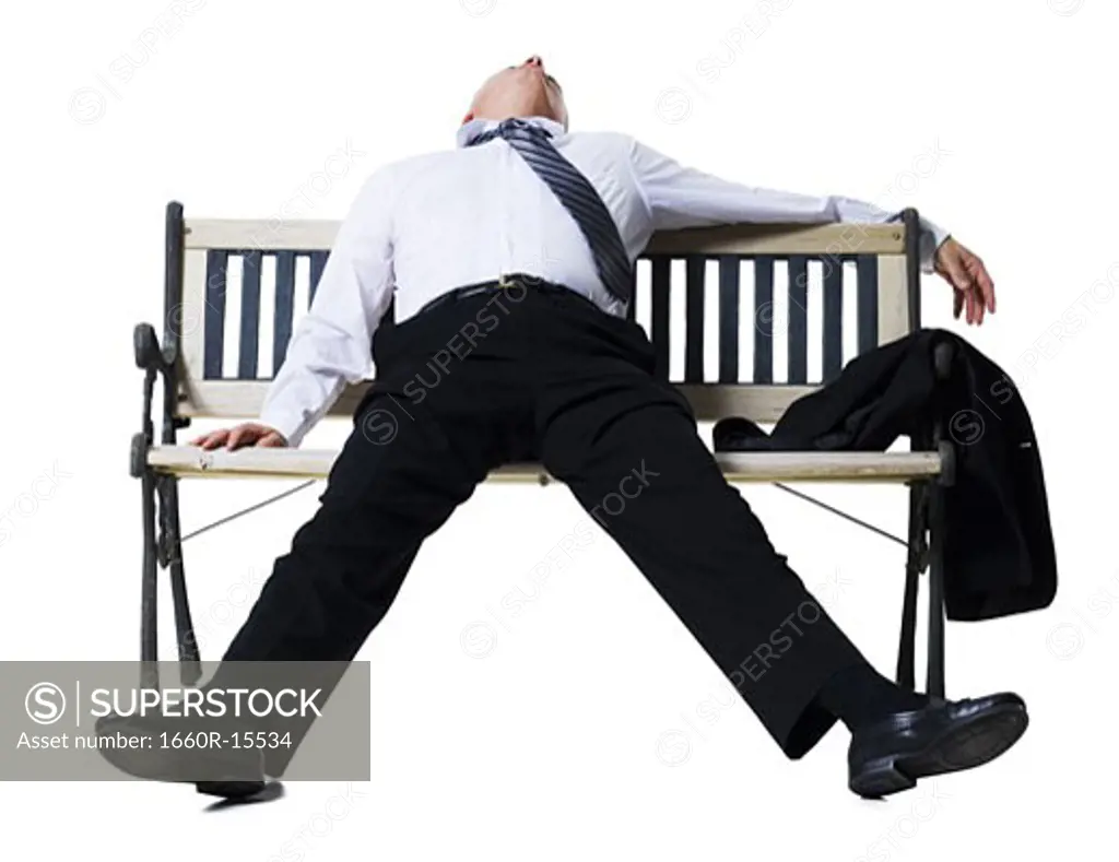 Businessman sleeping on a bench