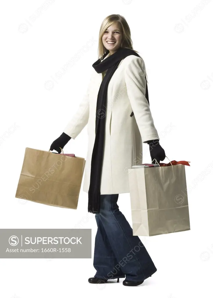 Portrait of a young woman carrying shopping bags