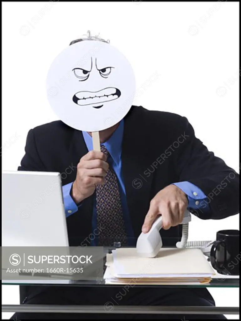 Businessman with Angry face mask taking phone off hook