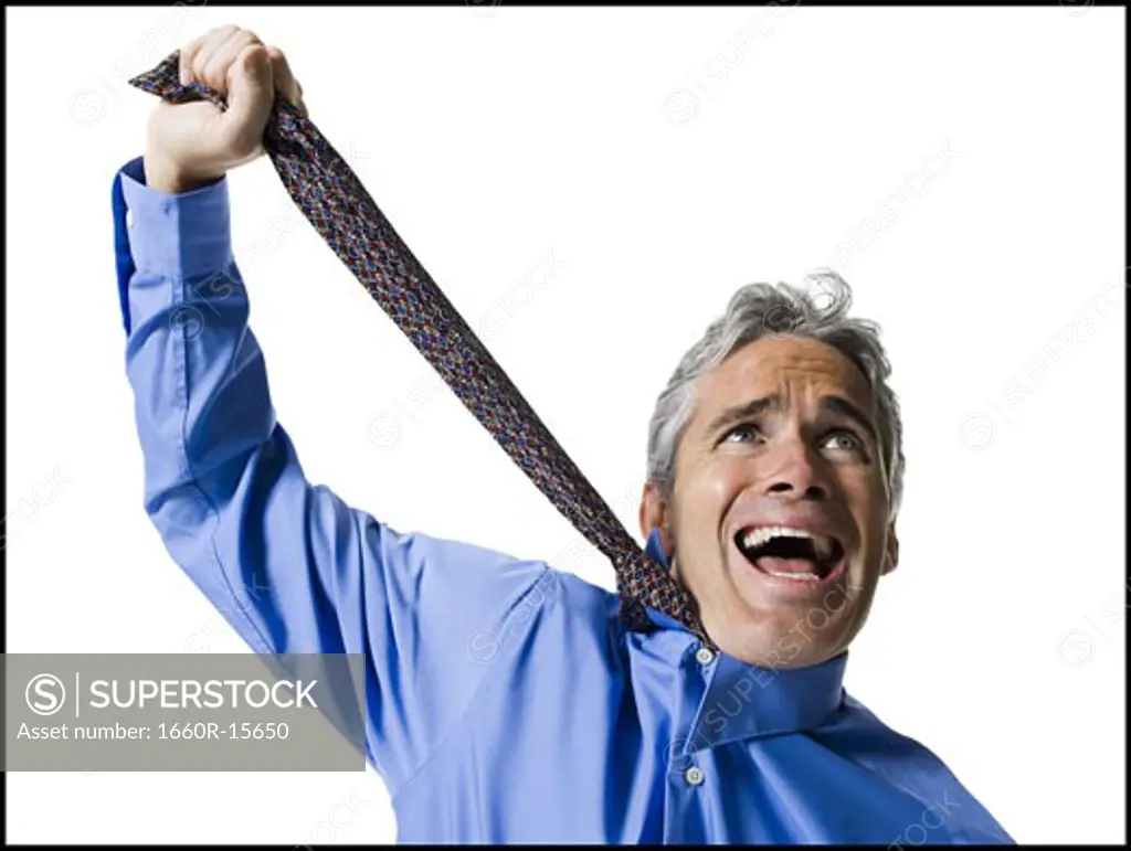 Man strangling himself with necktie