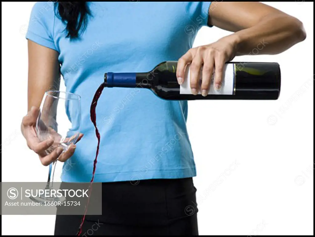 Distracted woman pouring red wine and missing glass