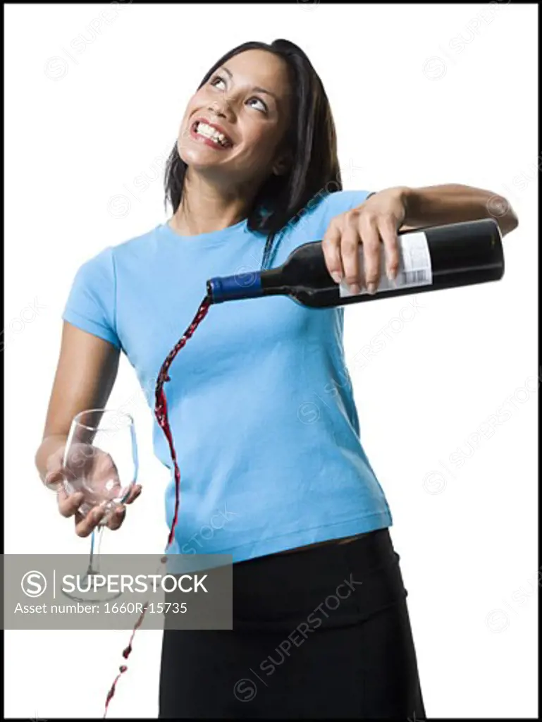 Distracted woman pouring red wine and missing glass