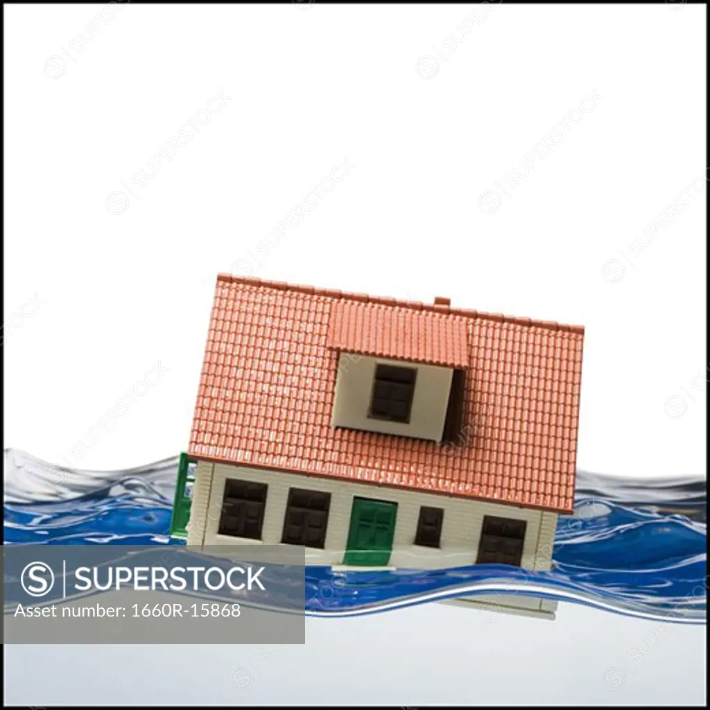 Flooded toy house floating in water