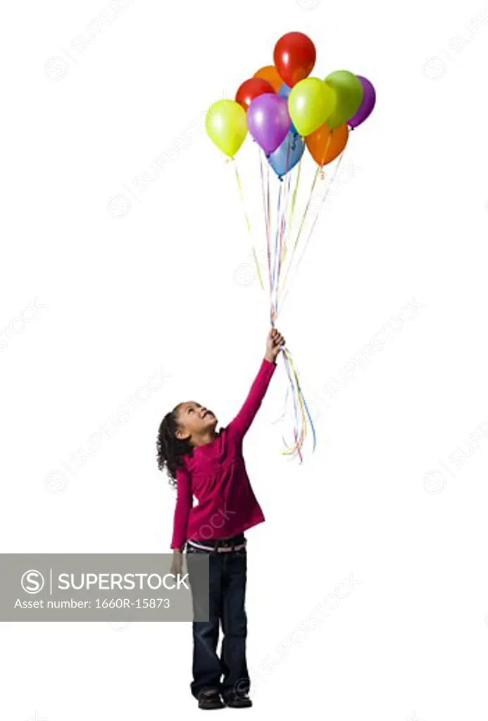 Young girl holding balloons