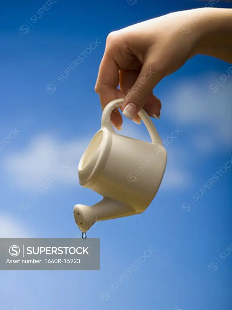 Last drop of water coming from watering can