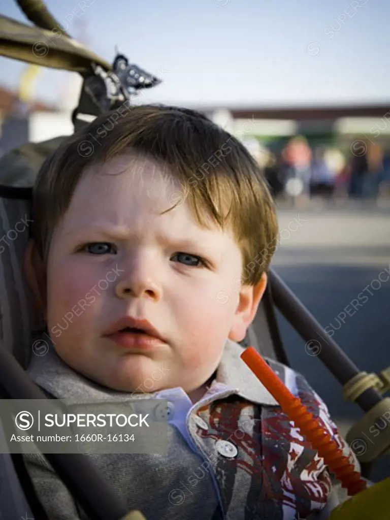 young boy in stroller