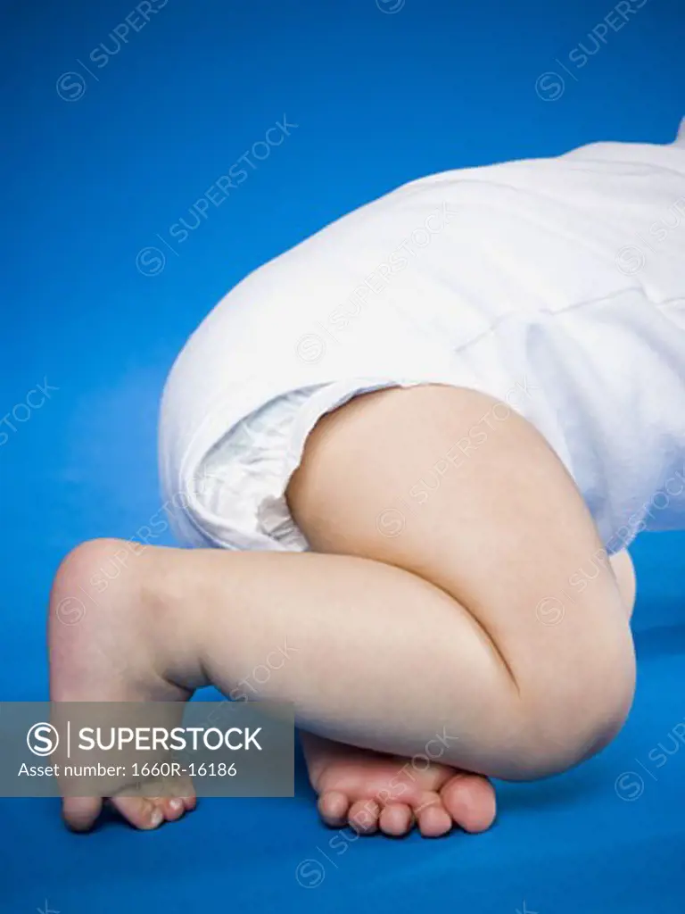 Waist down view of a baby crawling