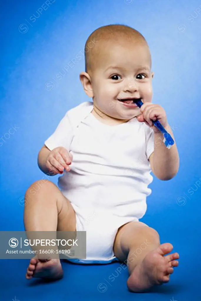 Baby chewing on toothbrush