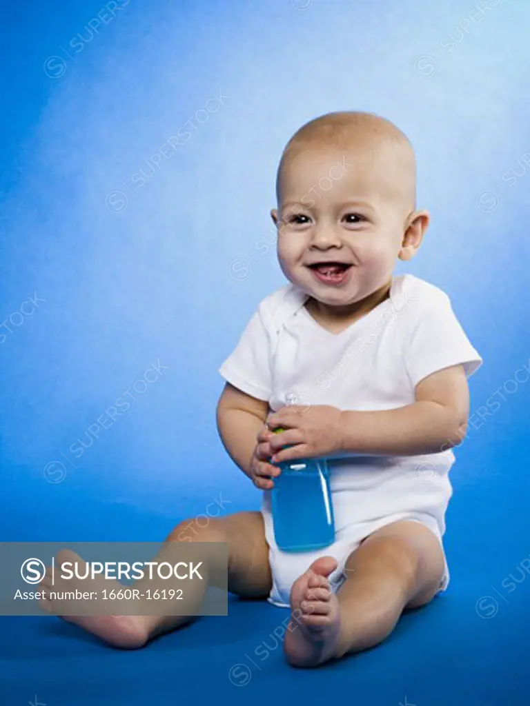 Baby sitting with bottle