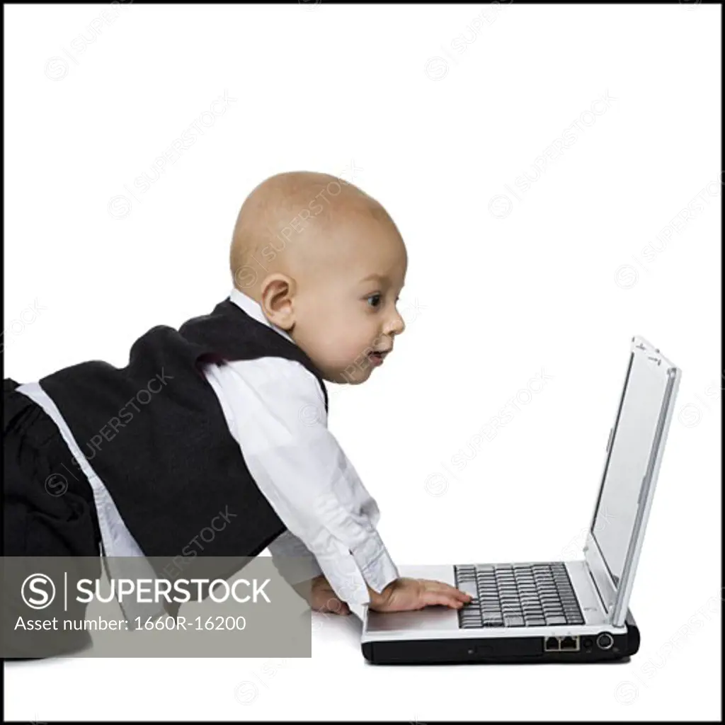 Baby boy in suit with laptop