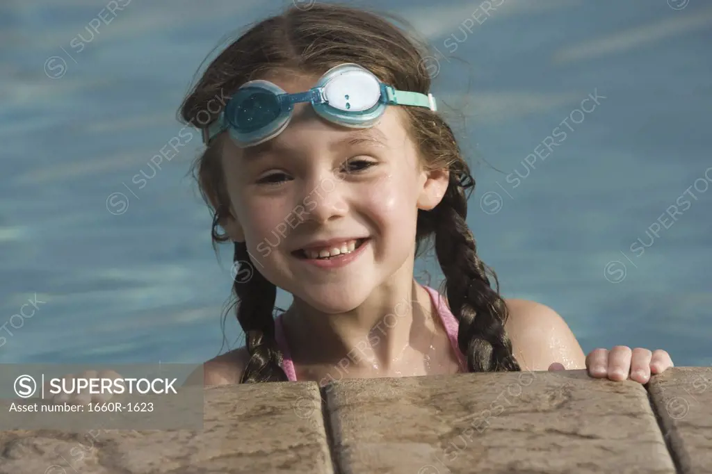 Portrait of a girl smiling in a swimming pool