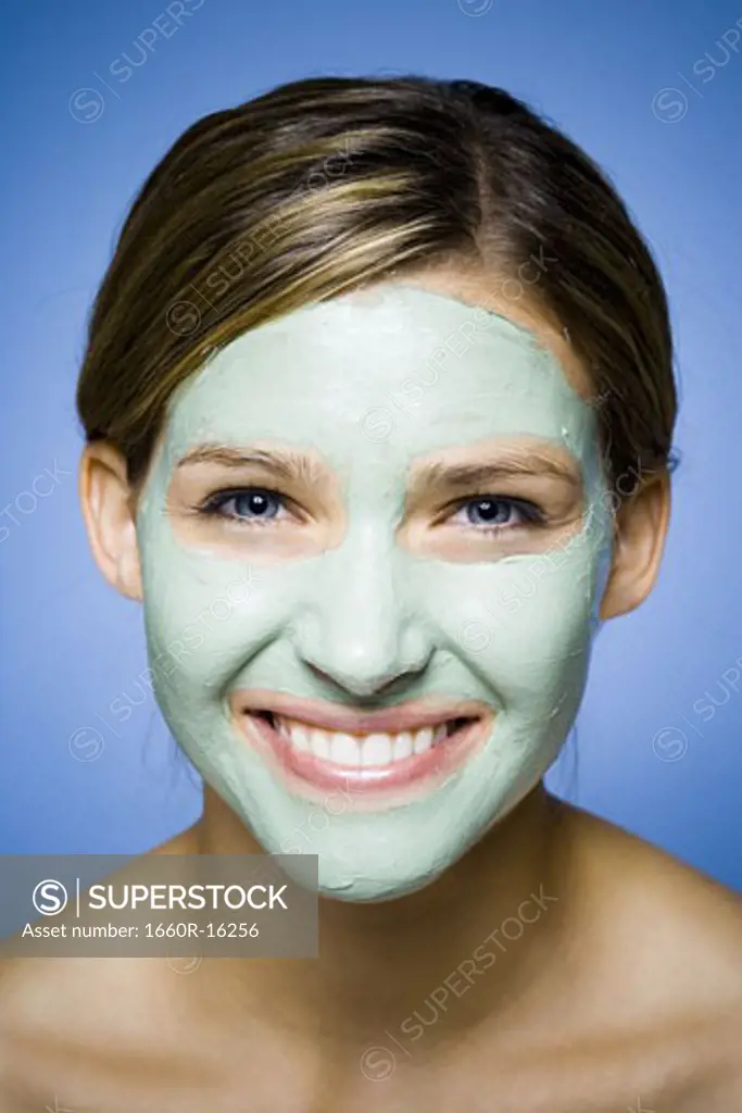 Woman with facial mask smiling