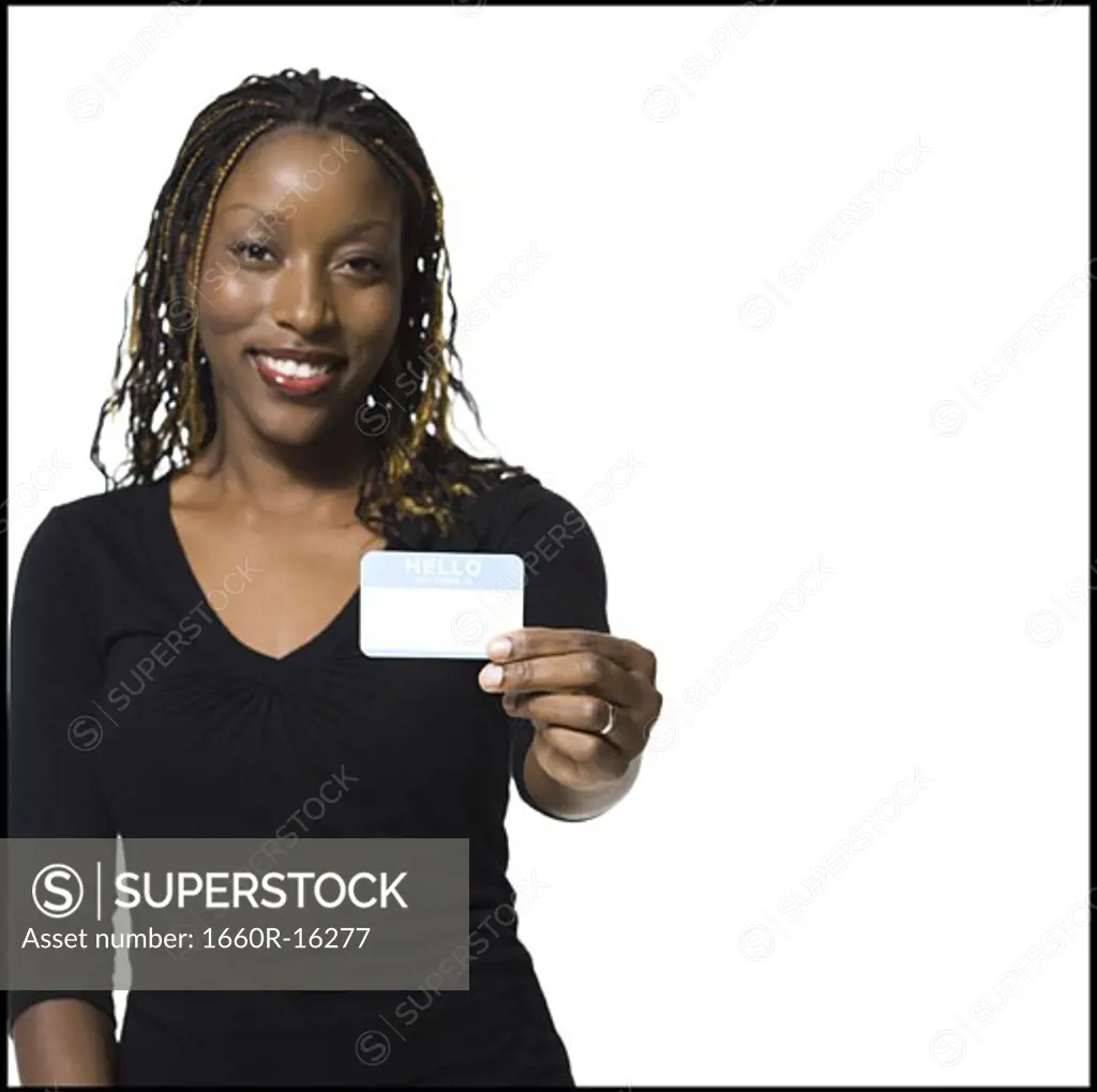 Woman holding name tag smiling