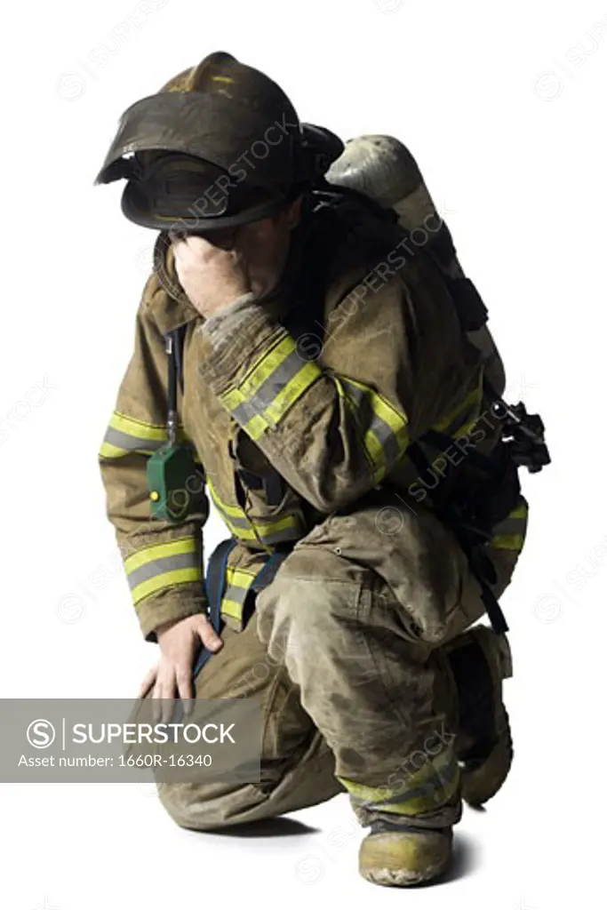 Firefighter crouching and sad