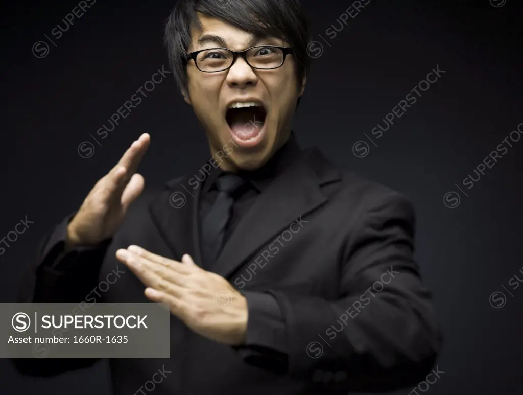 Portrait of a young man shouting,in martail arts pose