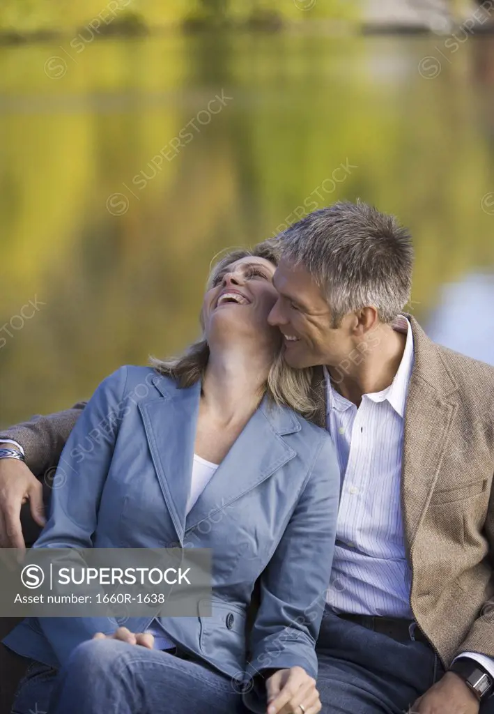 Mid adult woman and a mature man smiling