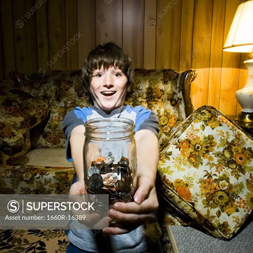 Boy with coin jar smiling
