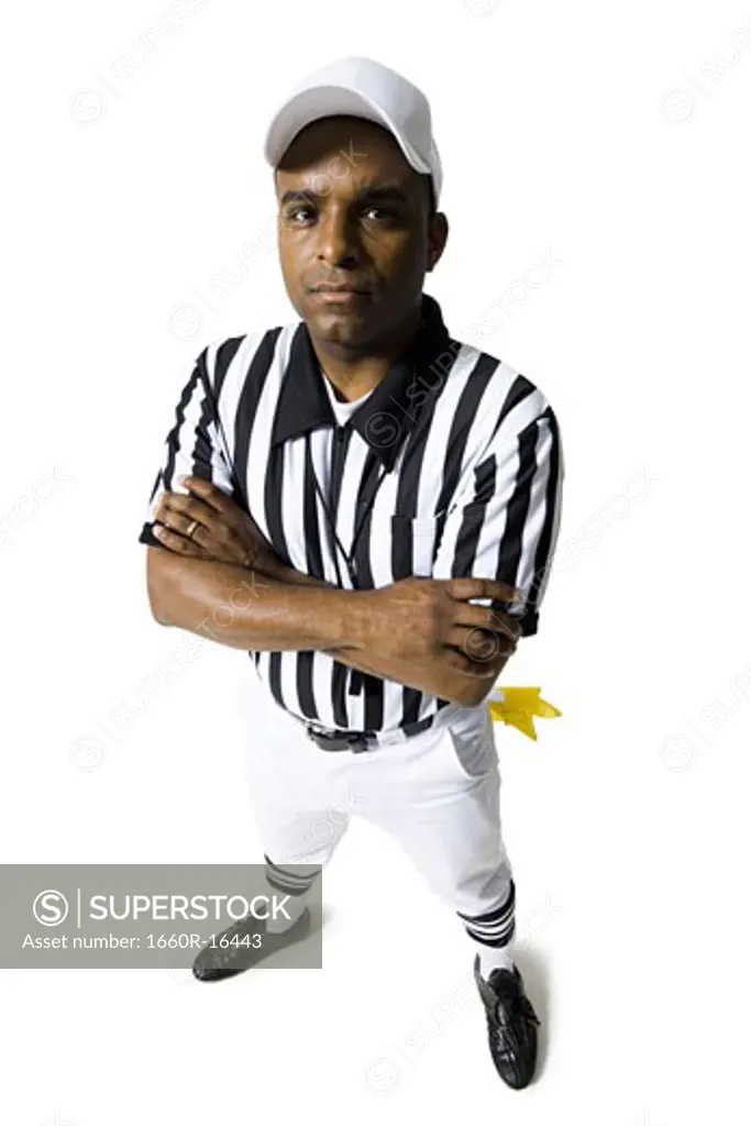 Referee standing with arms crossed