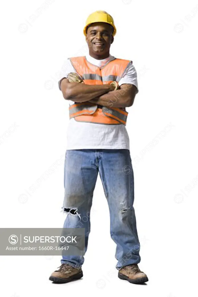 Male road worker with crossed arms and hardhat smiling