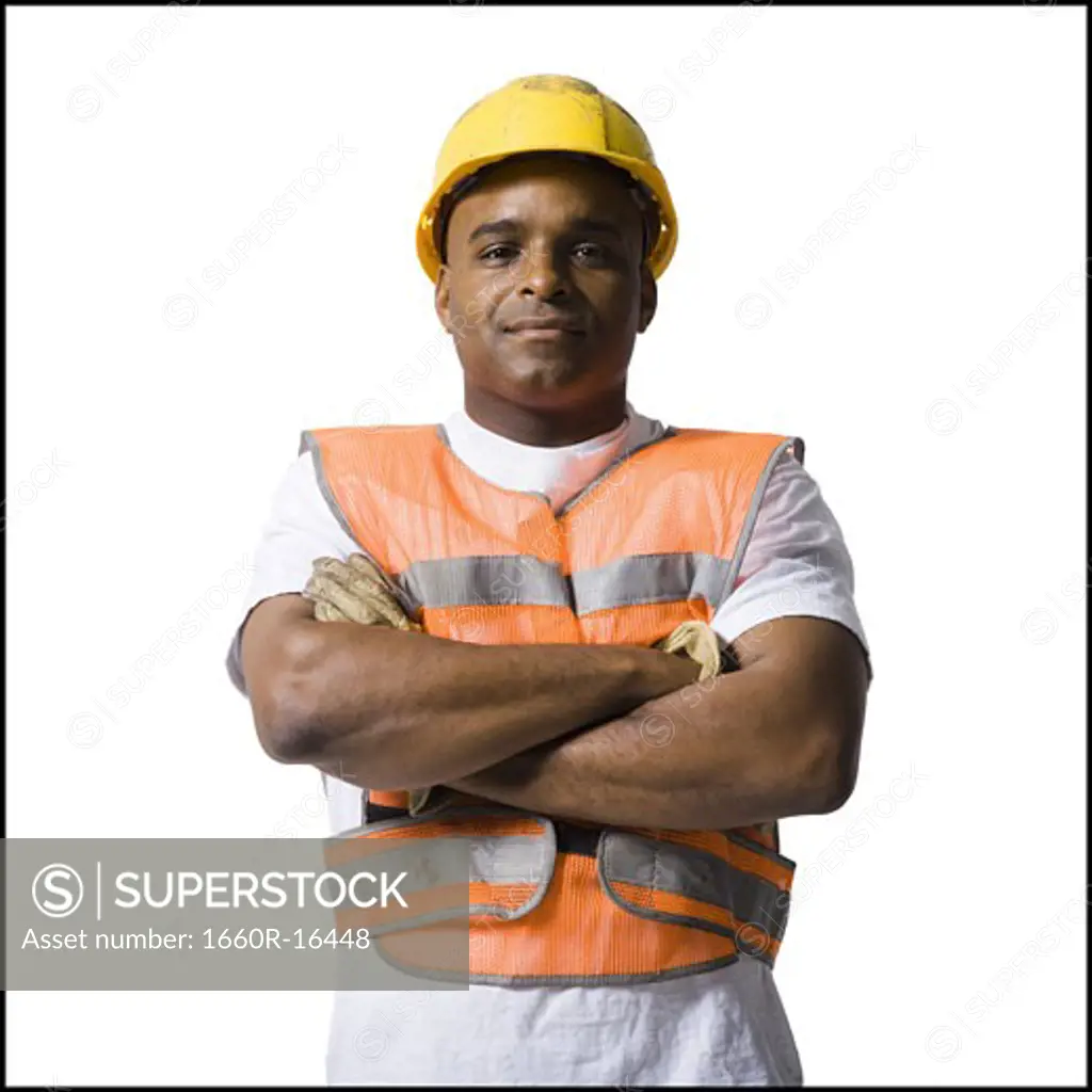 Male road worker with crossed arms and hardhat