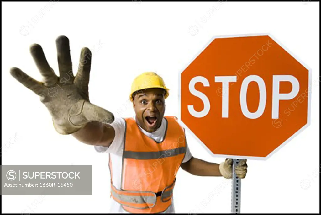 Male road worker with stop sign yelling