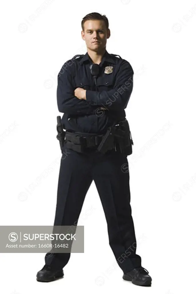 Male police officer standing with arms crossed