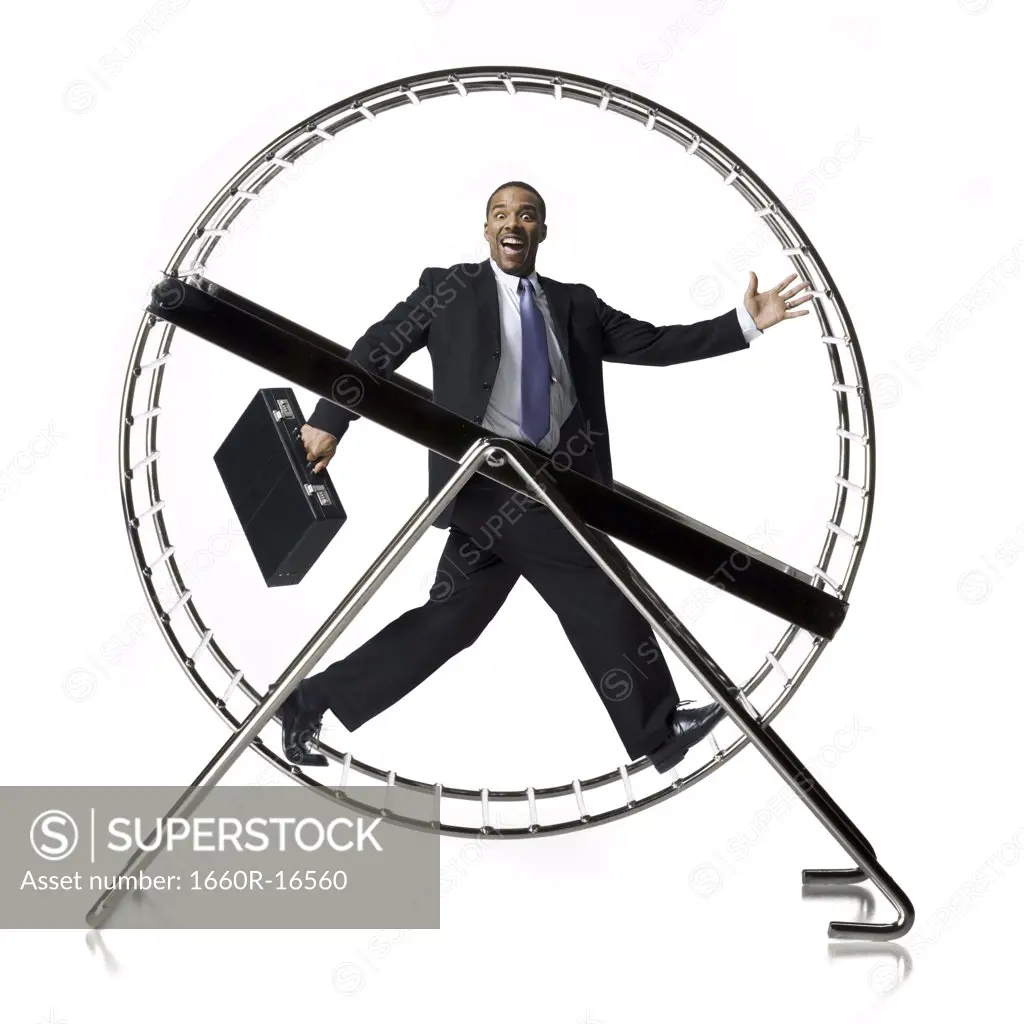 Businessman in rodent wheel smiling