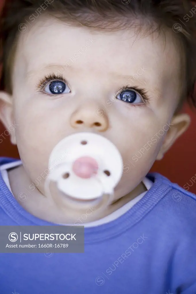 Baby with pacifier and blue eyes